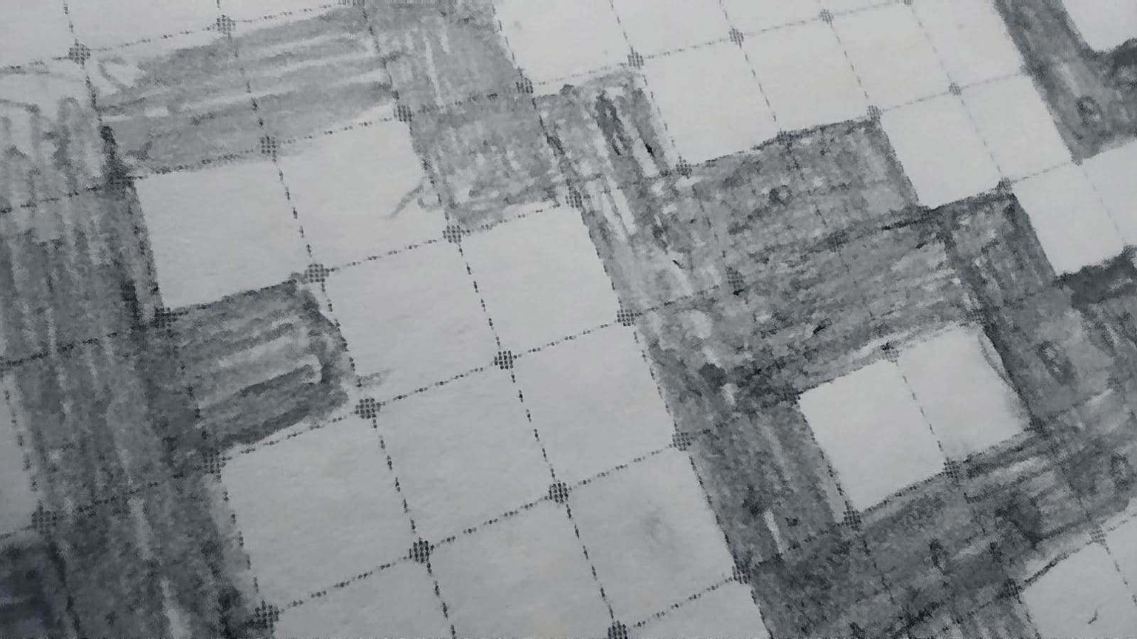 Das Bild zeigt einen Detailauschnitt des Entwurfs, welcher mit Bleistift auf kariertem Papier gezeichnet wurde. Ein Kästchen stellt ein Pixel dar.